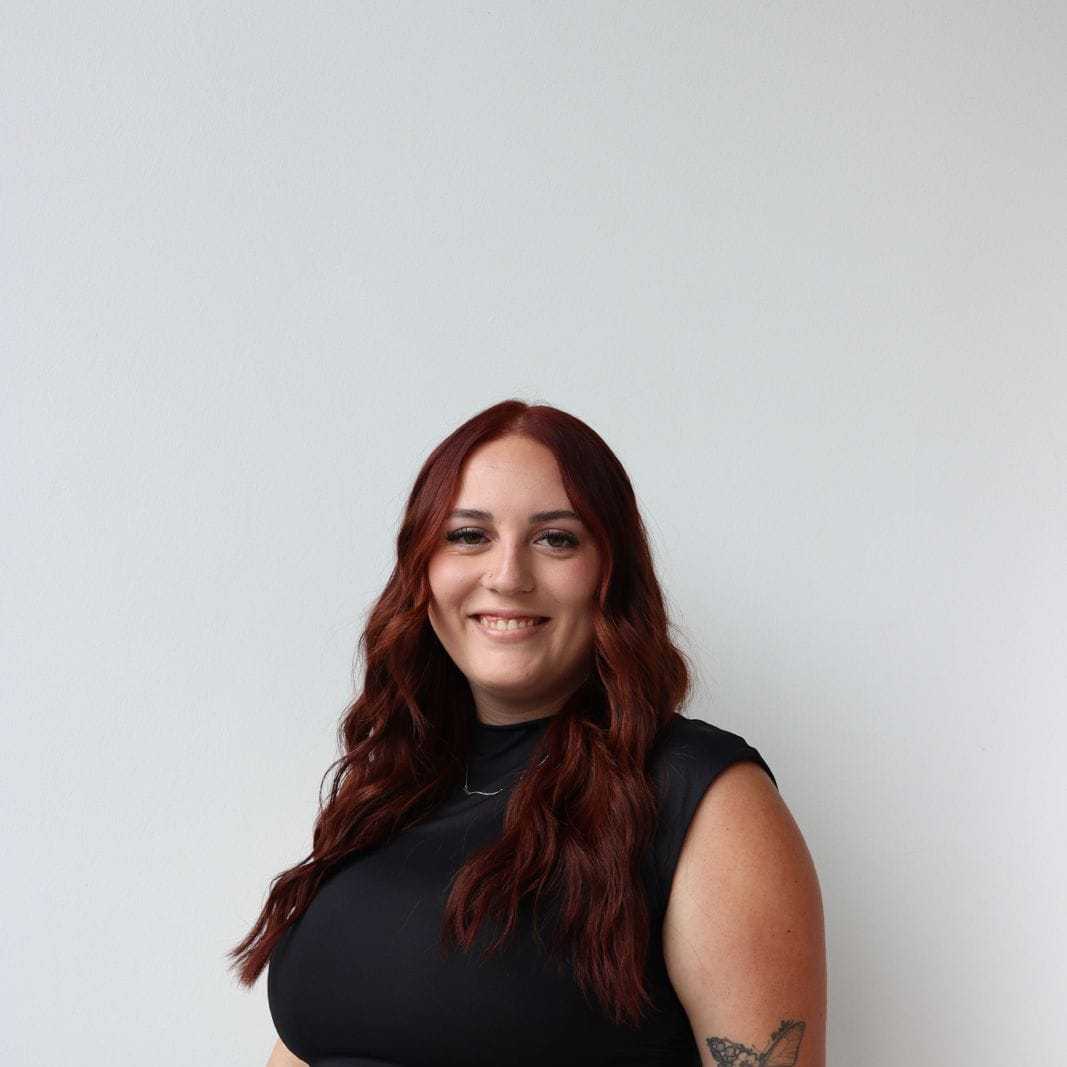 Portrait of Hannah Glover, a professional stylist at Raven Hair Co., showcasing their expertise and style.