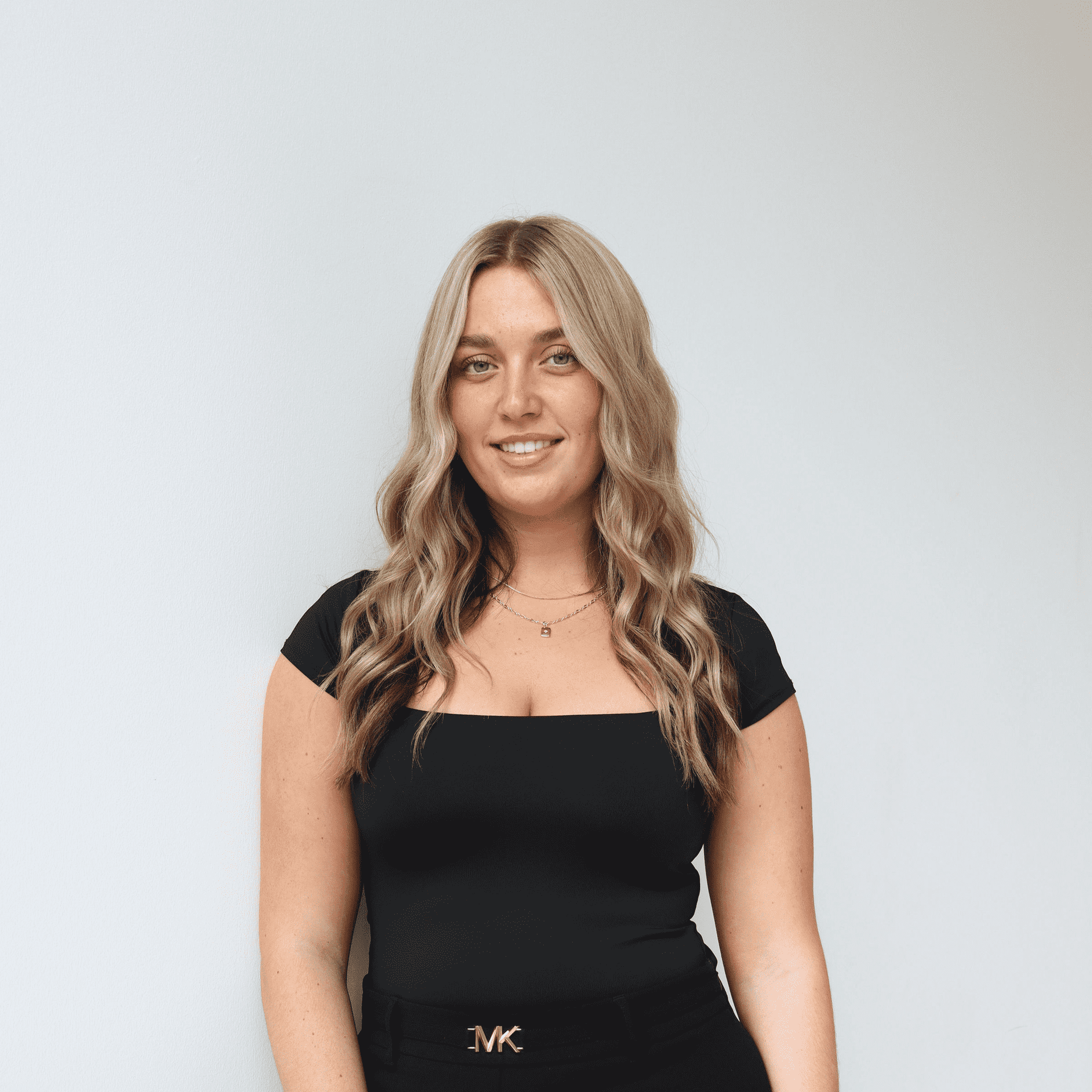Portrait of Payten Draper, a professional stylist at Raven Hair Co., showcasing their expertise and style.