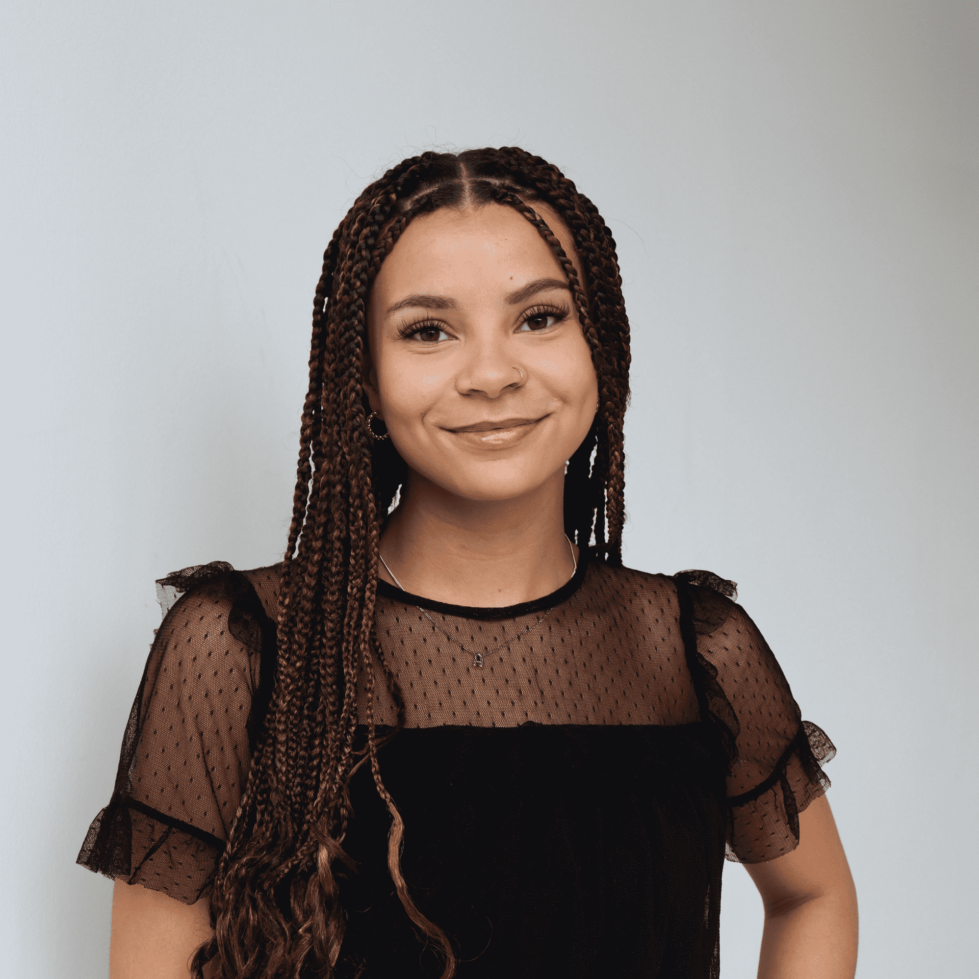 Portrait of Ava Nelson, a professional stylist at Raven Hair Co., showcasing their expertise and style.
