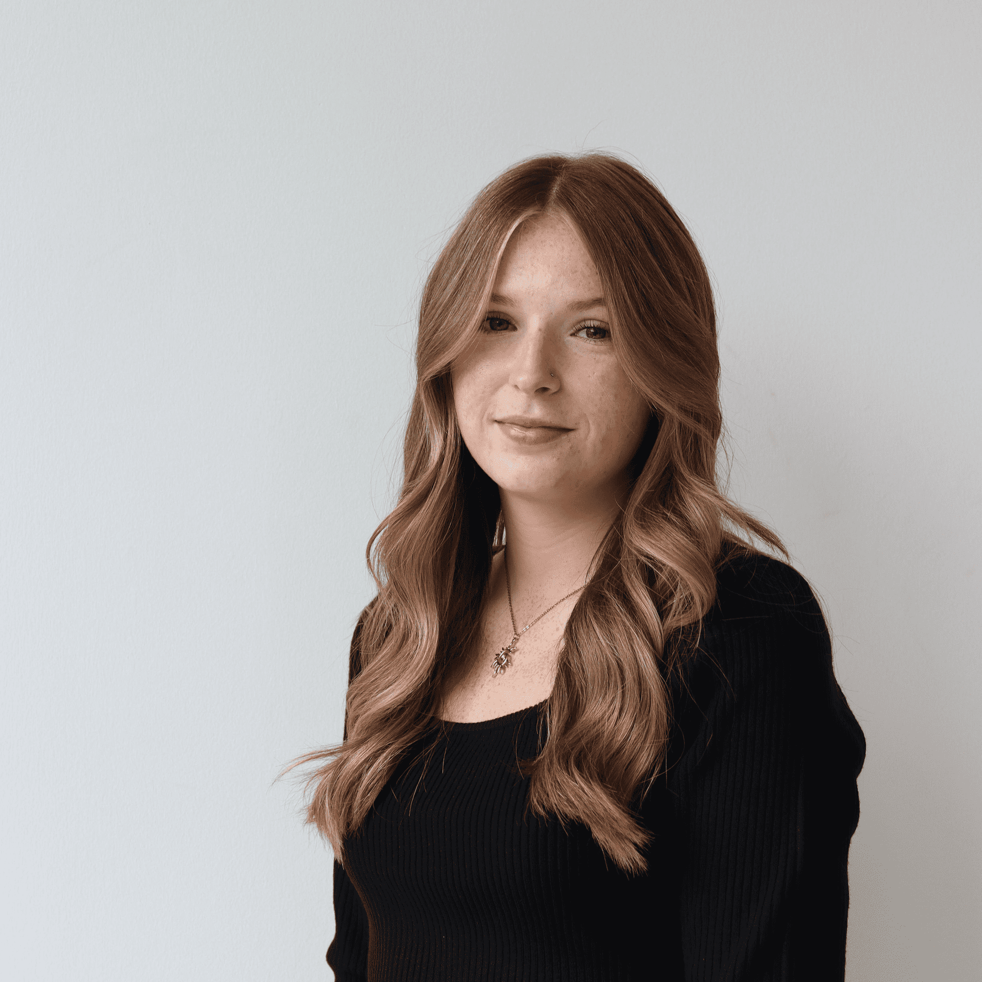Portrait of Daykota Semeniuk, a professional stylist at Raven Hair Co., showcasing their expertise and style.